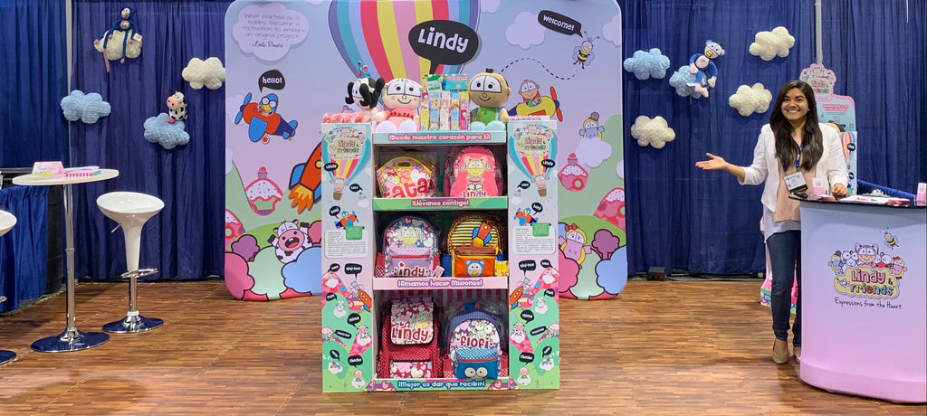 Lindy's booth at a convention with colorful displays and branded items.